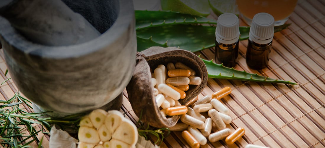 Health supplements alongside an aloe plant